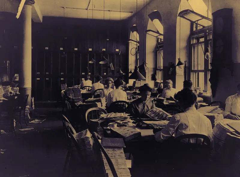 Rows of clerks inspecting printed currency at the Bureau of Engraving and Printing